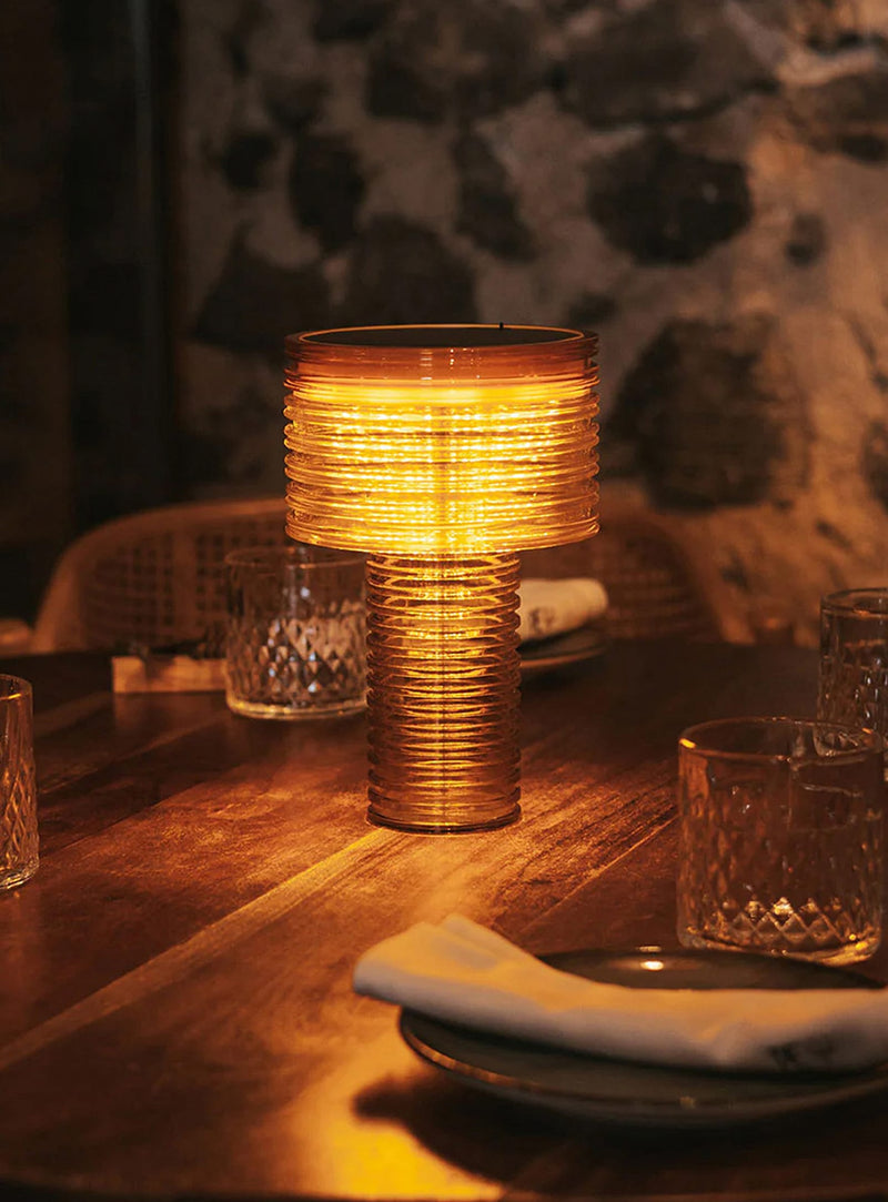 Ambar by Newgarden is a cordless table lamp with warm LED light, solar charging, USB-C recharge, and up to 20 hours of autonomy.