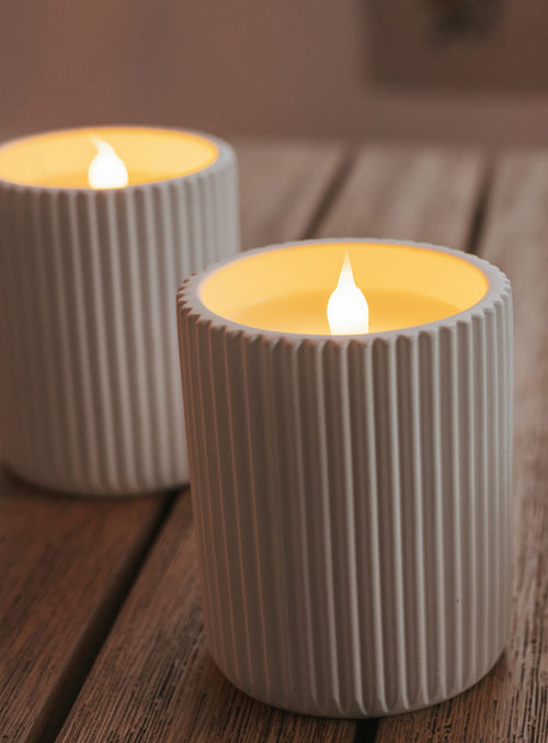 Dolo Ceramic by Newgarden is a flameless candle in natural wax with a white ceramic finish, realistic candle effect, remote control, and timer.