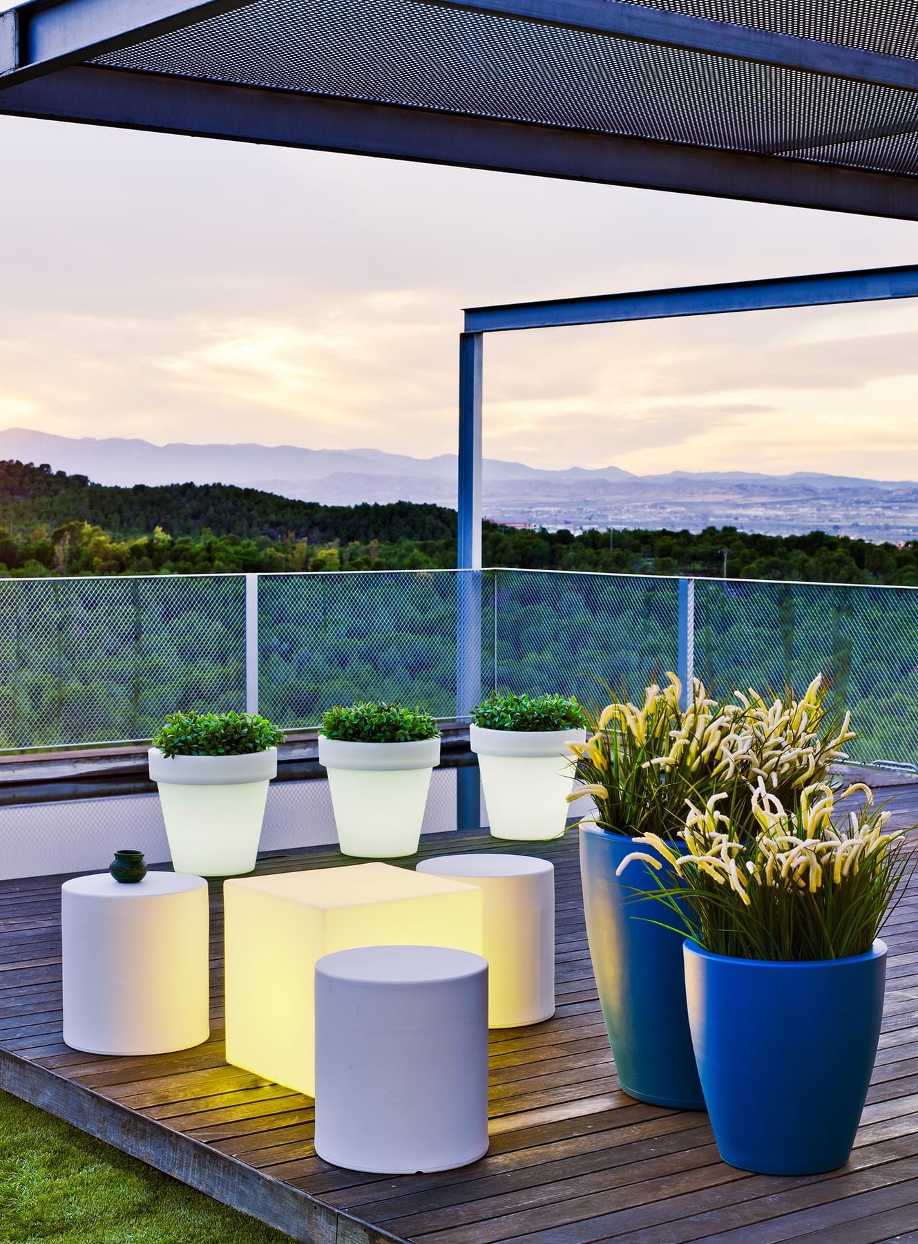 Magnolia illuminated planters arranged on a modern summer patio